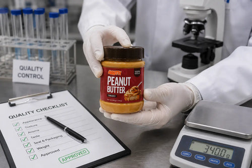 Quality inspection of a Nautty Creamy Peanut Butter 340g jar in a food-grade laboratory to ensure safety, freshness and consistent quality before every jar is packed.